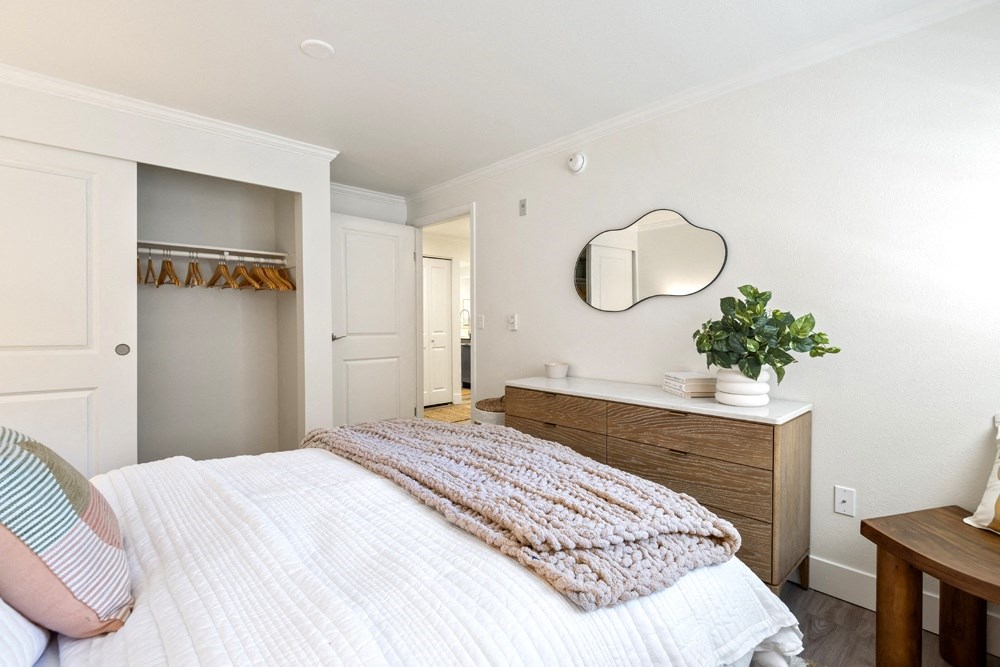 a bedroom with a white bed and a mirror on the wall at Lakemont Orchard, Issaquah, WA 98027