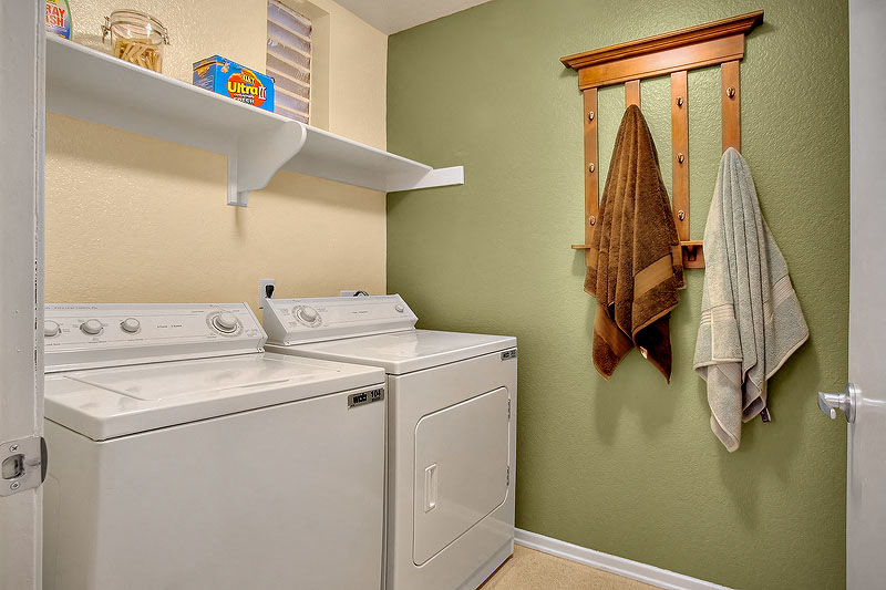 a white washer and dryer in a green room