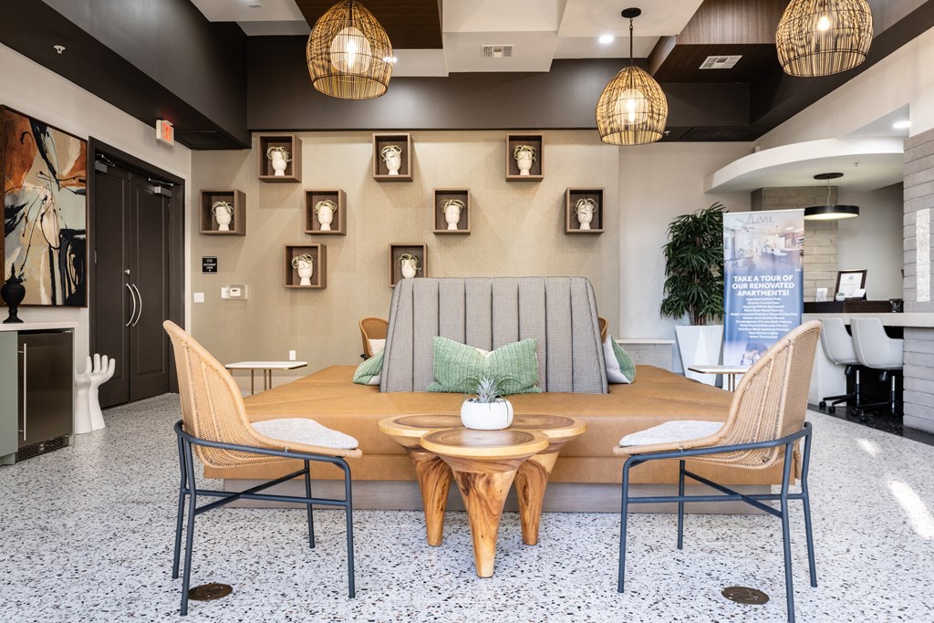 a living room with a couch and chairs and a table