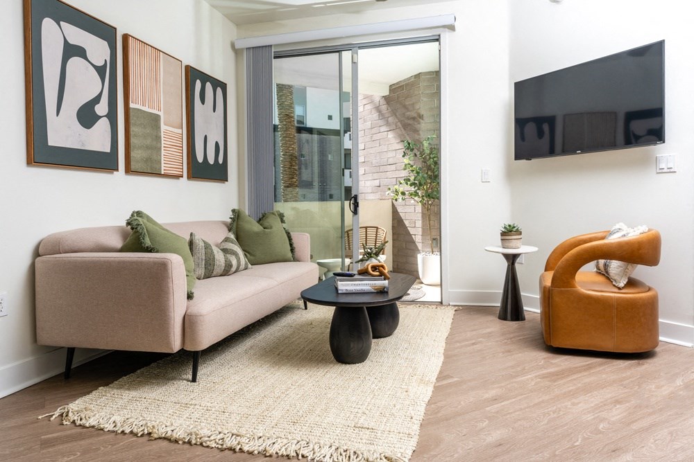 a living room with a couch and a chair and a sliding glass door