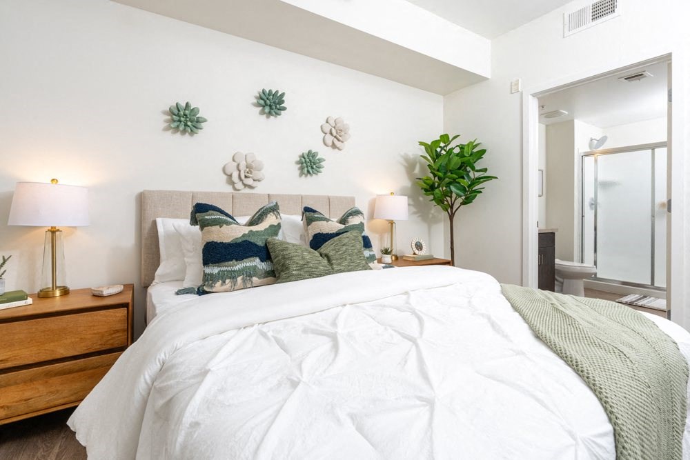 a bedroom with a large bed and some decorations on the wall
