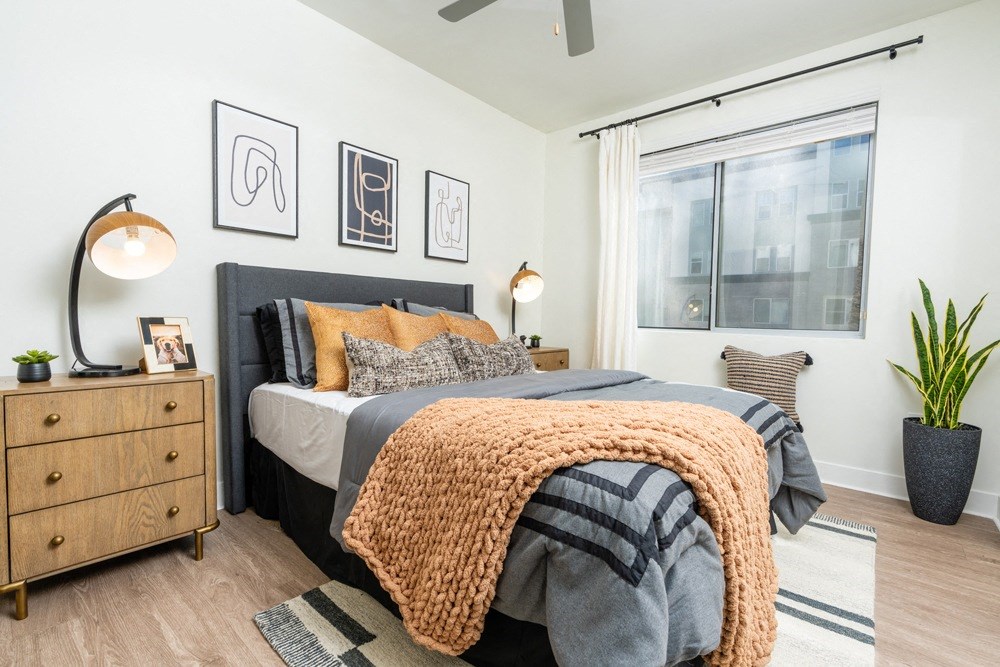 a bedroom with a bed and a large window