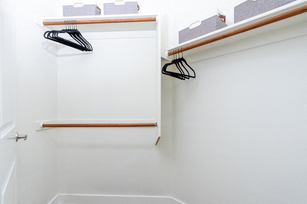 a white closet with a shoe rack on the wall