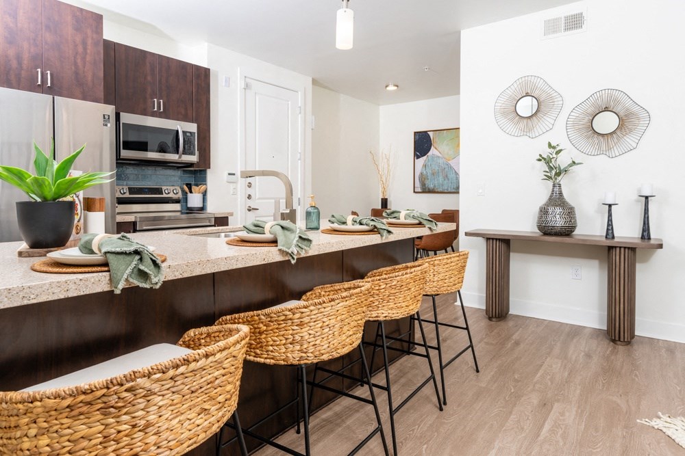 a kitchen with a breakfast bar and a table with chairs