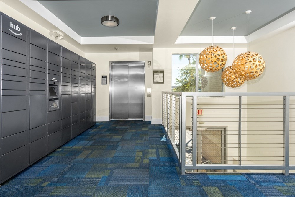 the lobby of a building with lockers and a fire place
