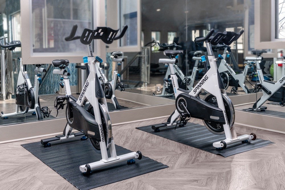 a row of exercise bikes in a gym