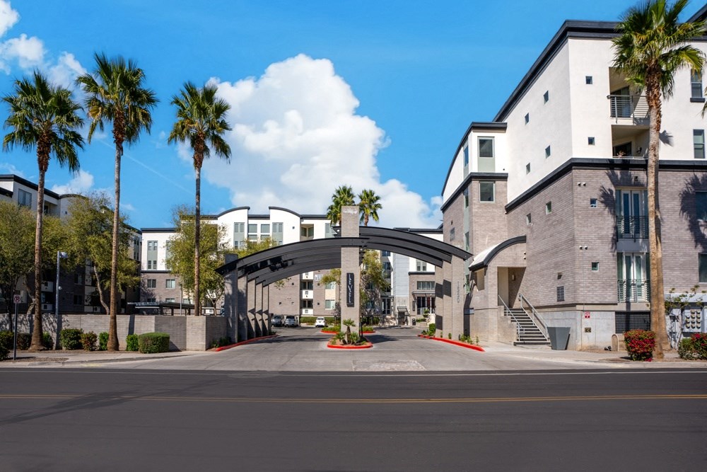 a city street with buildings and palm trees