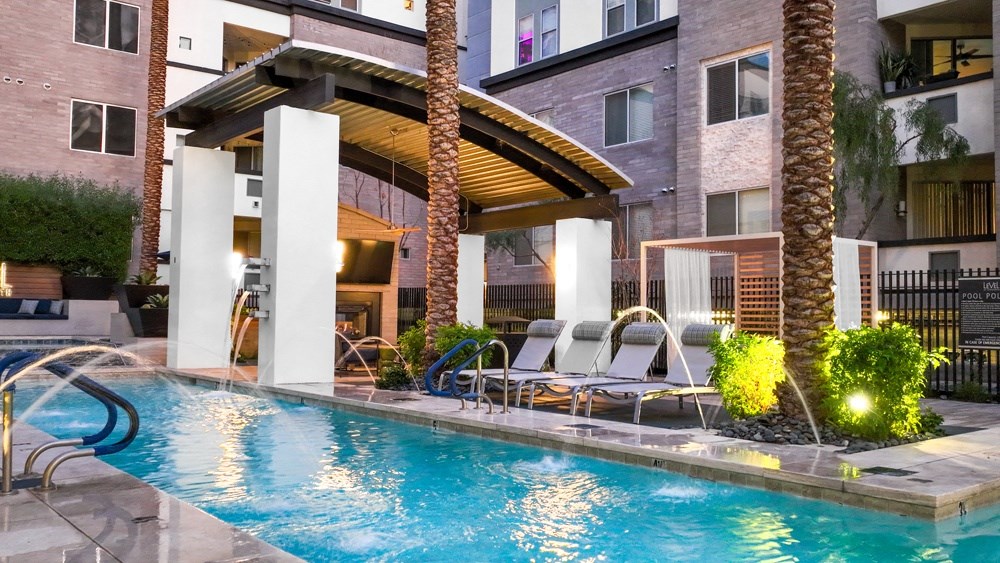 a swimming pool at a hotel with palm trees