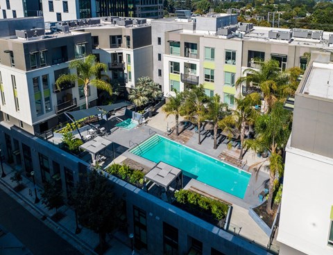 an aerial view of a swimming pool in front of a building