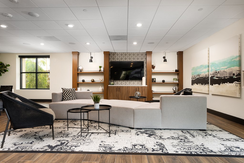 a rendering of a living room with a large couch and a tv