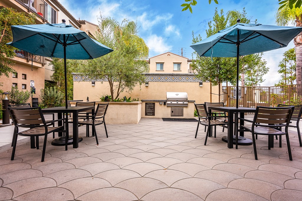 an outdoor patio with tables and umbrellas