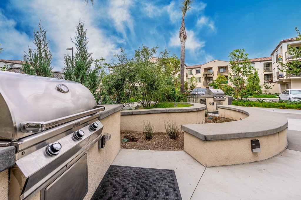 the patio has a gas grill and seating area
