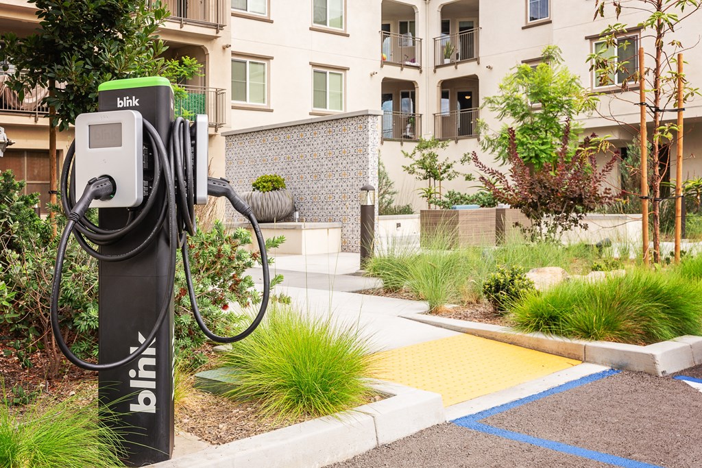 an electric charger in front of an apartment building