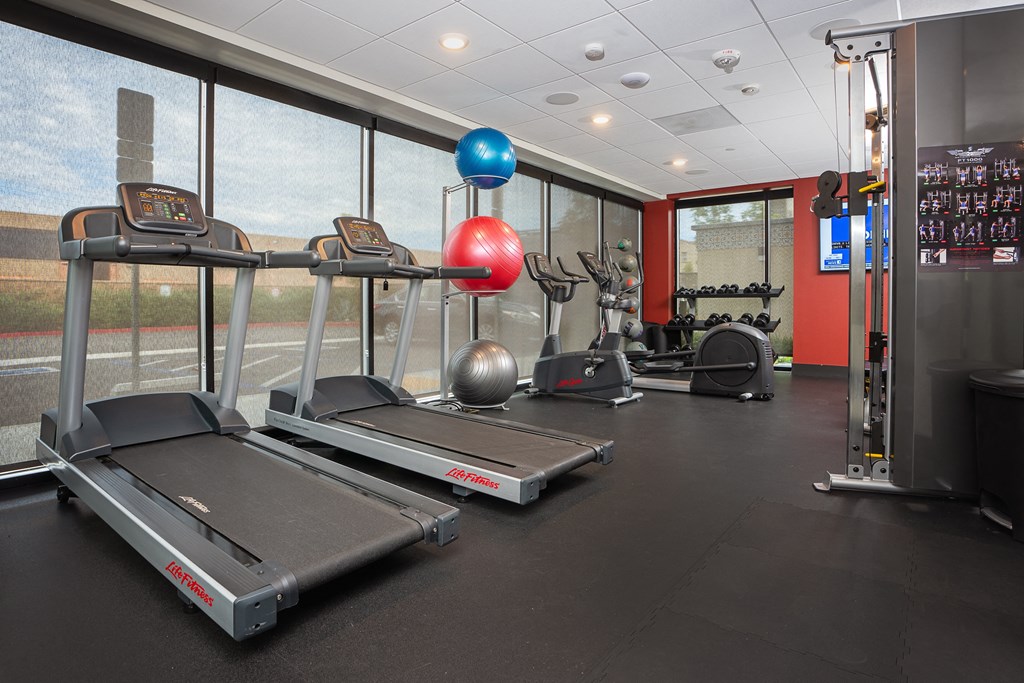 a gym with treadmills and other exercise equipment