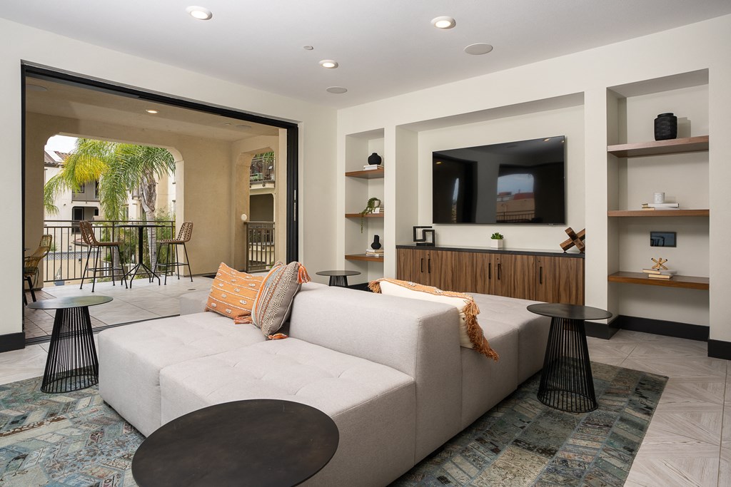 a living room filled with furniture and a flat screen tv