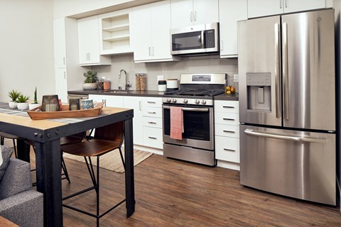 a kitchen with stainless steel appliances and a table