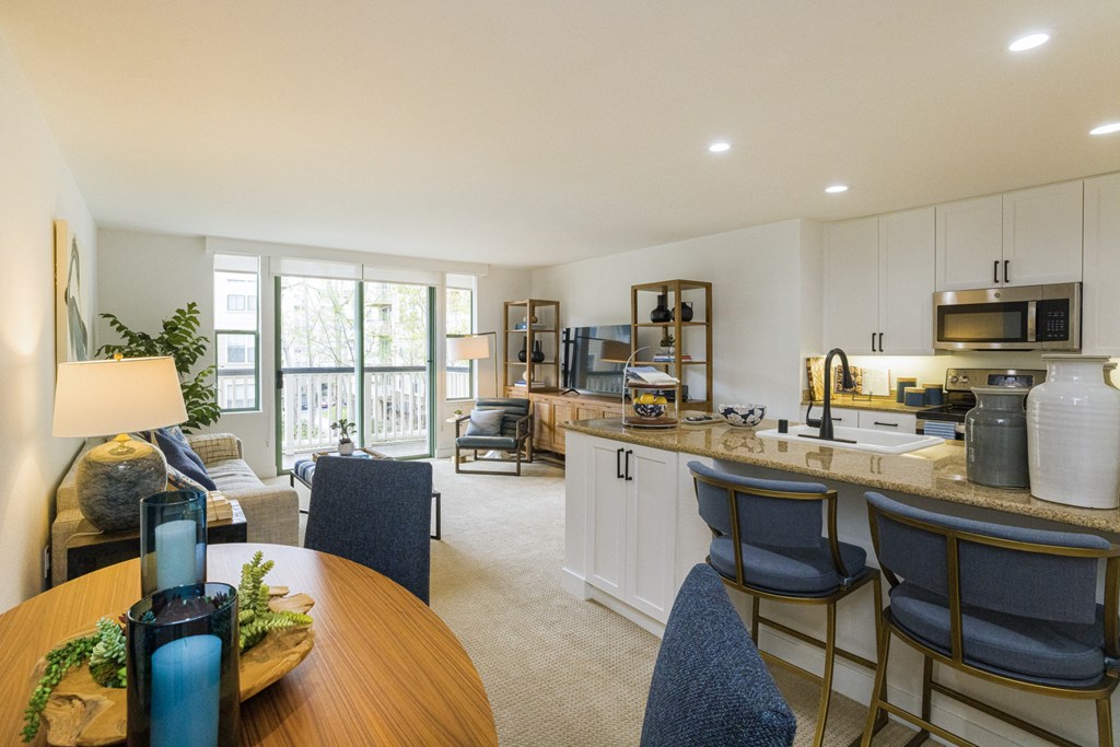 a living room with a kitchen and a dining room