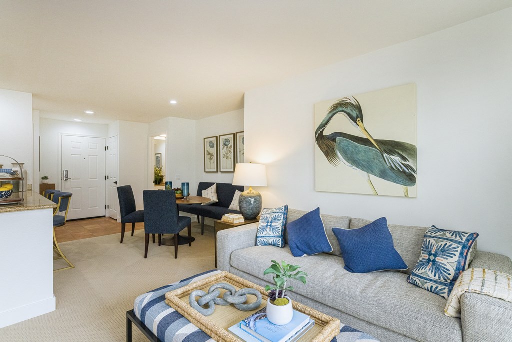 a living room with a couch and a table with chairs