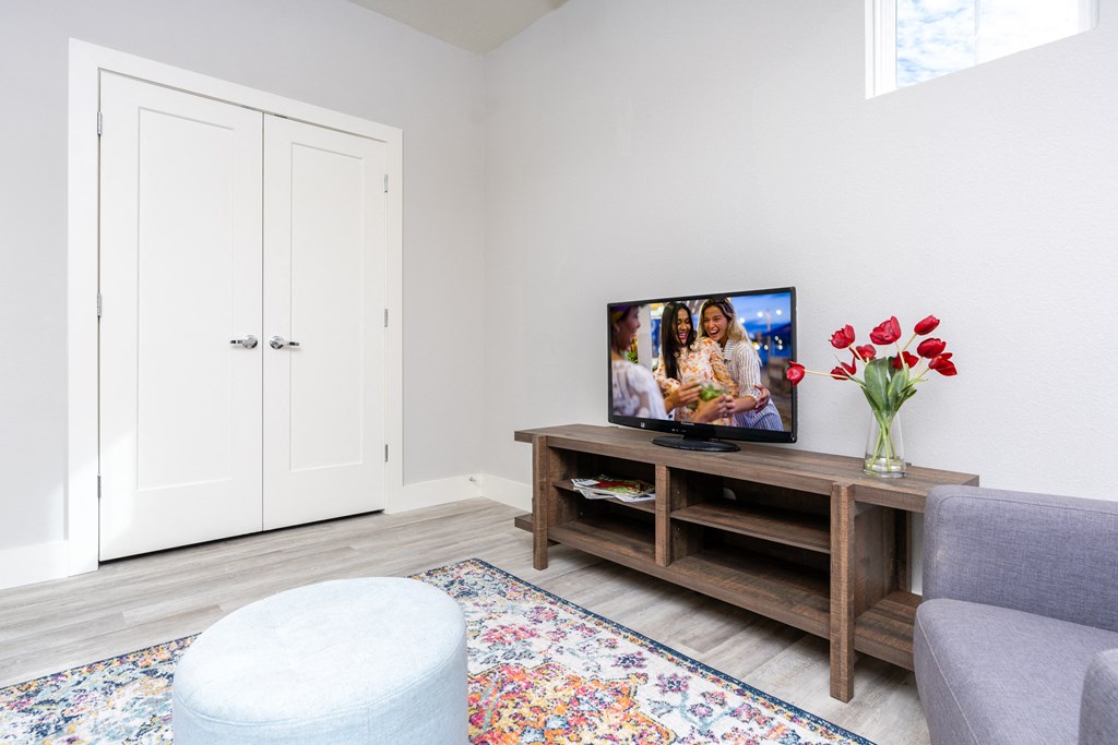 living room with a tv and a couch at Mihir Taylor, Taylor