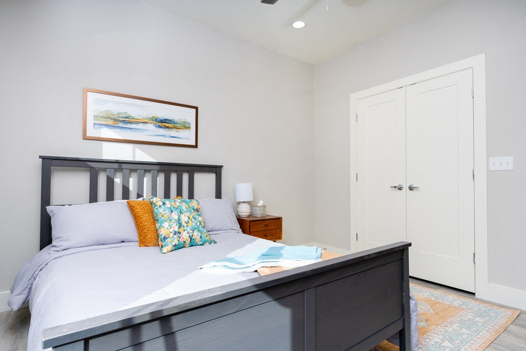 model bedroom with a bed and two closets at Mihir Taylor, Taylor