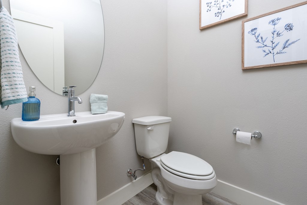 a bathroom with a toilet and a sink and a mirror at Mihir Taylor, Taylor, TX 76574