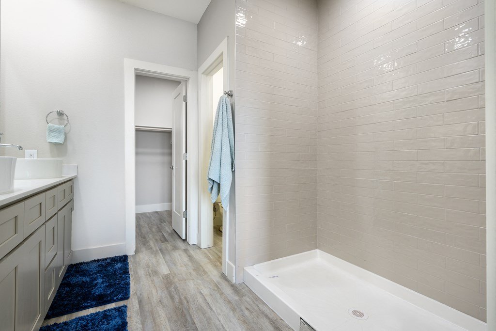 model bathroom with a walk in shower and a sink and a mirror at Mihir Taylor, Taylor, TX 76574