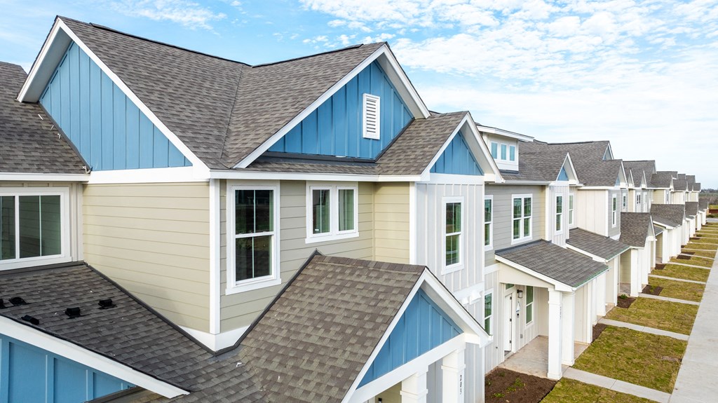 neighborhood a row of blue and white houses with roofs at Mihir Taylor, Taylor, 76574