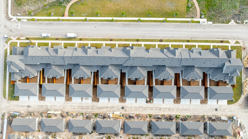 an aerial view of a row of roofs in a parking lot at Mihir Taylor, Taylor, 76574