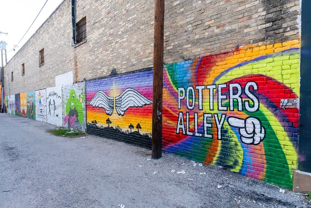 a mural that says potters alley on a brick wall at Mihir Taylor, Texas 76574