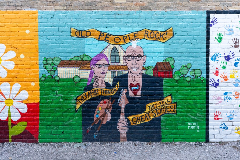 a mural on the side of a brick wall at Mihir Taylor, Texas
