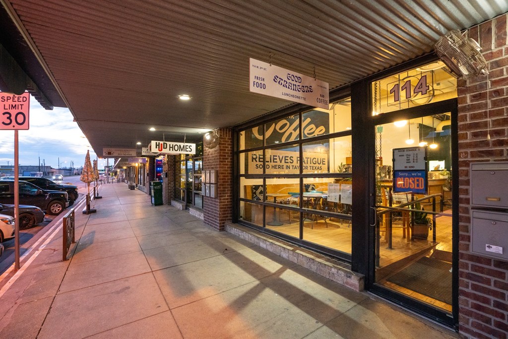 the sidewalk outside of a restaurant on a city street at Mihir Taylor, Taylor