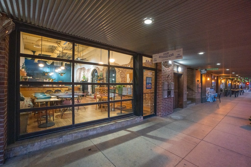 the sidewalk outside of a restaurant with a large window at Mihir Taylor, Taylor, 76574