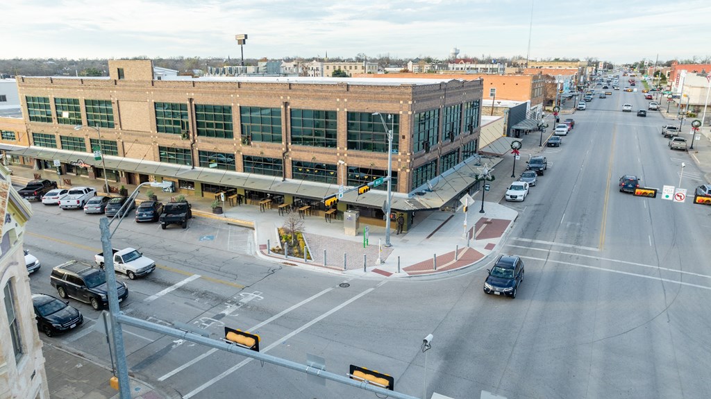 an aerial view of an intersection in a city with cars and a building at Mihir Taylor, Taylor, TX 76574