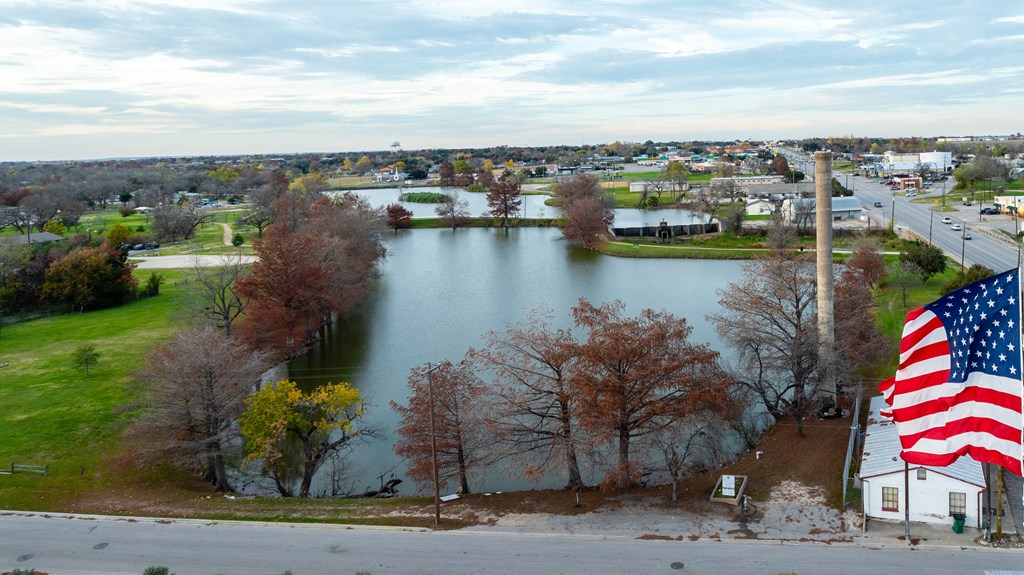an aerial view of a lake with an flag in the foreground at Mihir Taylor, Texas 76574