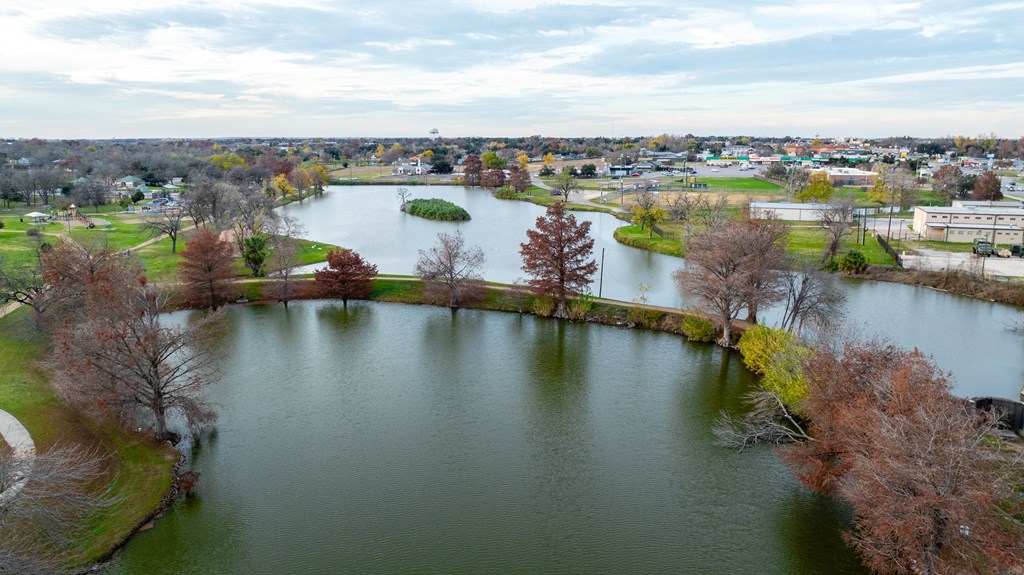 an aerial view of a lake with a city in the background at Mihir Taylor, Taylor, Texas