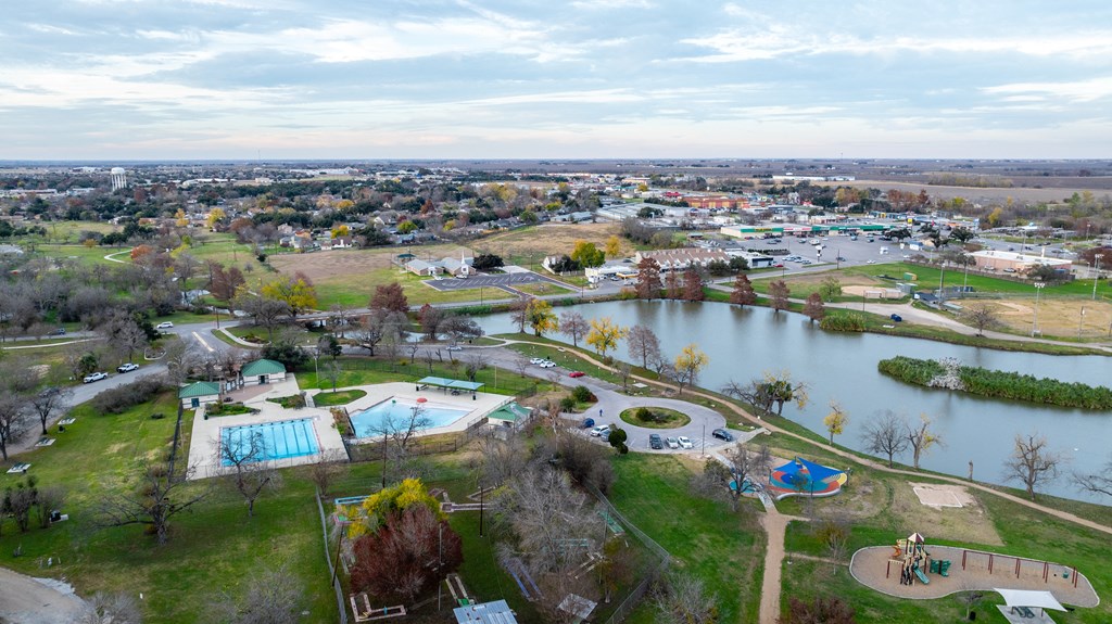 an aerial view of a park with a lake and a city in the background at Mihir Taylor, Taylor, 76574
