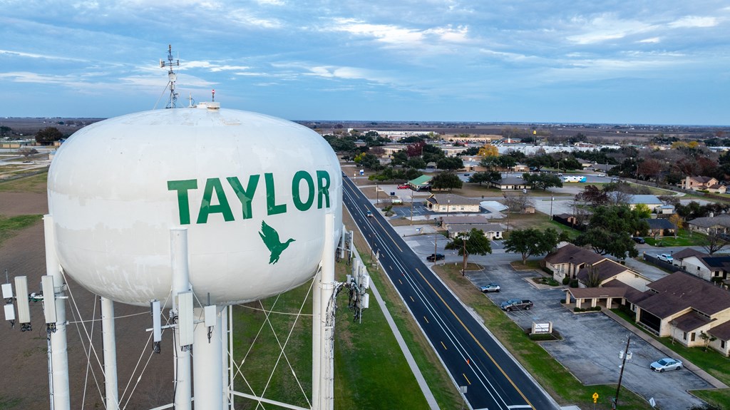 a water tower with the name of the city of taylors water tower at Mihir Taylor, Taylor, Texas