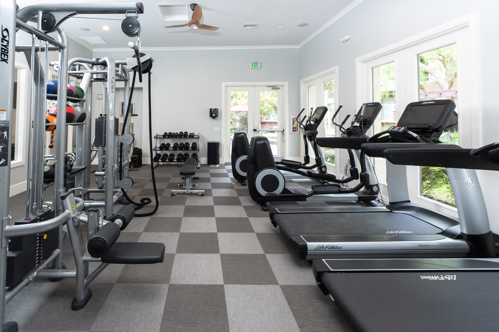 Apartments for Rent in Chino Hill CA - Spacious Fitness Center with Stylish Interior and Various Gym Equipment
