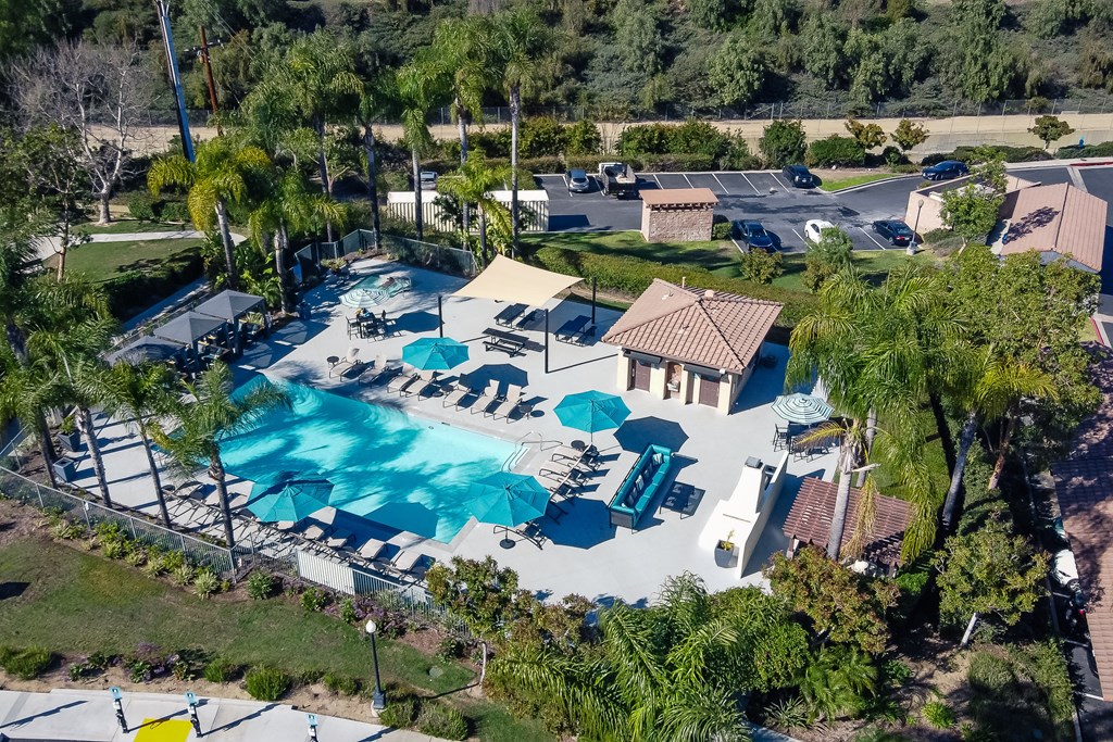 Chino Hills, CA Apartments For Rent - Missions At Chino Hills - Pool With Grill Area, Lounge Chairs, And Umbrellas.