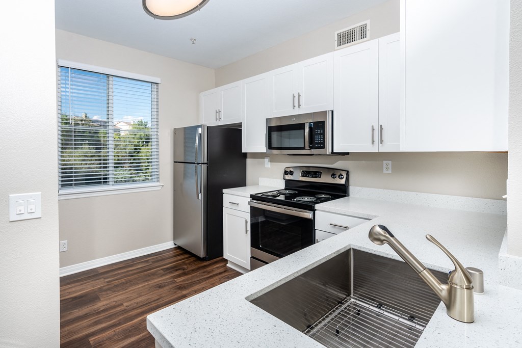 Chino Hills CA Apartments - Missions at Chino Hills - Modern Kitchen with Wood-Style Flooring and a Side Window