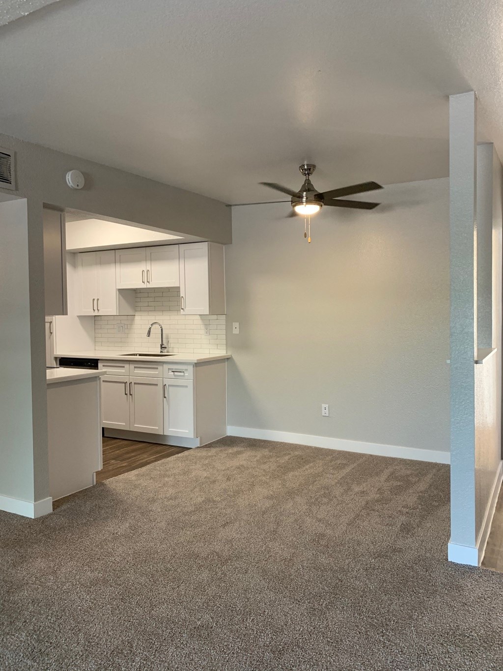 an empty living room and kitchen with a ceiling fan at Monaco at McCormick Ranch, Scottsdale, 85258