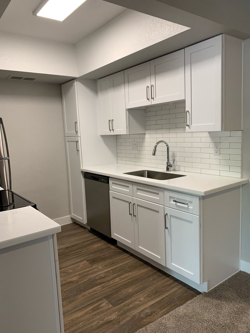 an empty kitchen with white cabinets and a sink at Monaco at McCormick Ranch, Arizona 85258