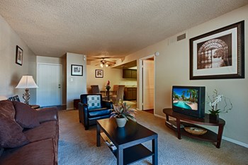 Apartments for Rent in McCormick Ranch - Monaco at McCormick Ranch - Open-Concept Living Area with Dining Room, Kitchen, and Beige Carpeting - Photo Gallery 5
