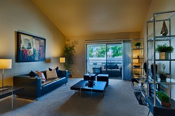 Apartment McCormick Ranch AZ - Monaco at McCormick Ranch - Living Room with Carpeting, Beige Walls, and Sliding Glass Patio Doors - Photo Gallery 3