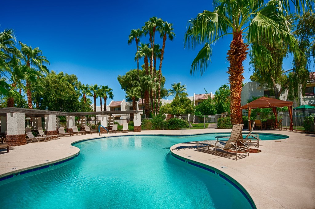 Resort-Style Pool Area with Palm Trees, Lounge Chairs, and a Cabana at Monaco at McCormick Ranch, Scottsdale, AZ 85258