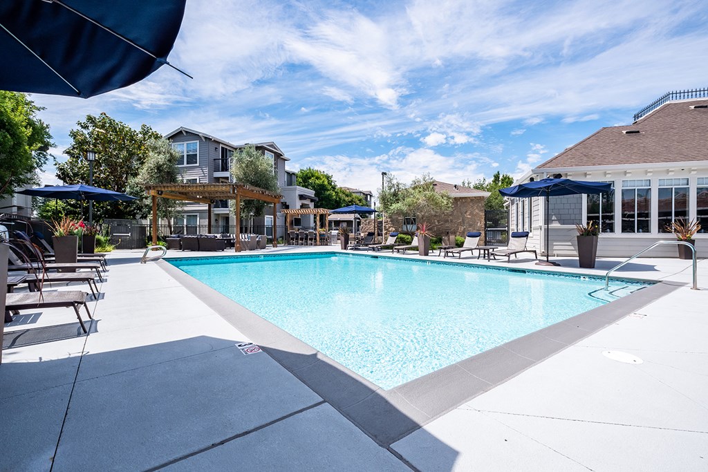Outdoor pool area with lounge chairs