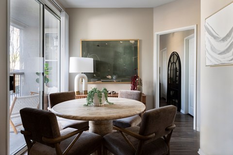 A dining room with a round table and chairs at Montrachet Apartments, Napa, CA