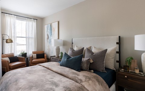 A bedroom with a large bed and a painting on the wall at Montrachet Apartments, Napa