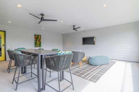 A dining room with a table and chairs.