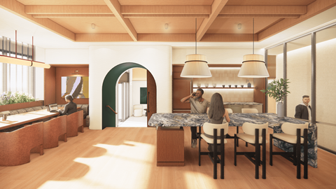 A group of people are sitting around a table in a room with a green archway.